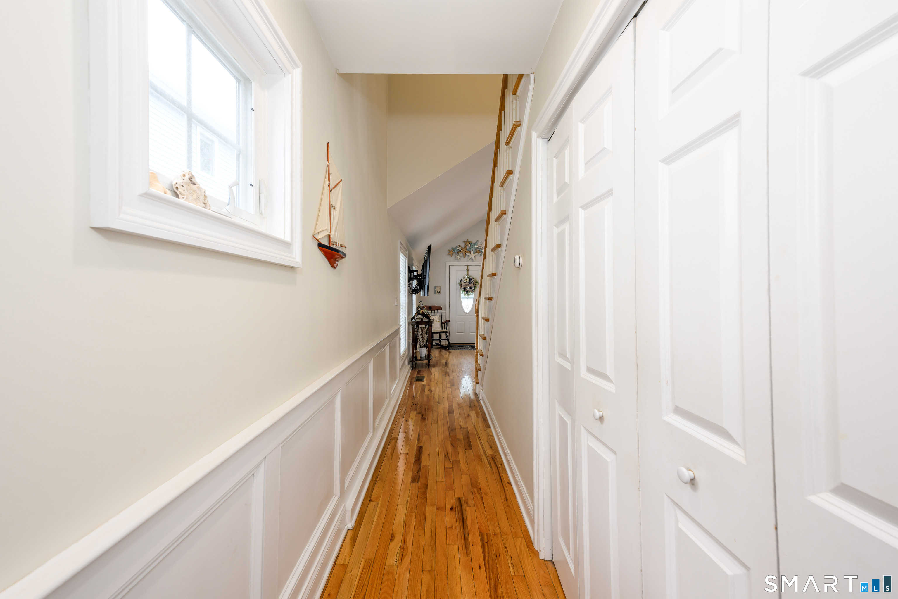 58 Minor Road East Haven, CT 06512 - Photo 15 of 40 Hallway that leads from main living area to primary suite. Washer and Dryer are in the closet to the right