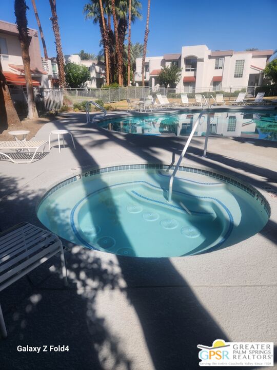 401 El Cielo Road, Unit 93 Palm Springs, CA 92262 - Photo 16 of 17 a view of a swimming pool with a yard