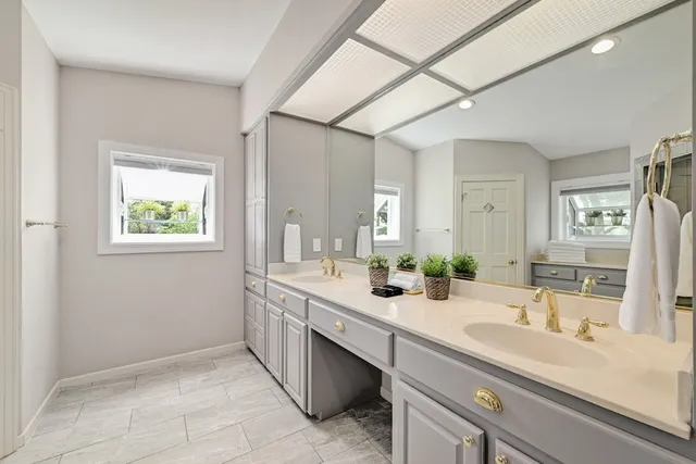 an aerial view of residential houses with outdoor space and trees