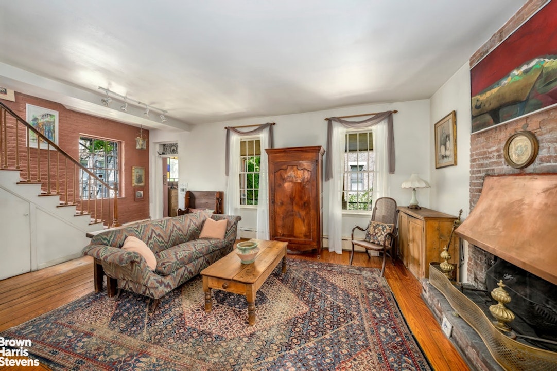 422 West 46th Street, Unit 2R Manhattan, NY 10036 - Photo 4 of 10 a living room with furniture and a fireplace