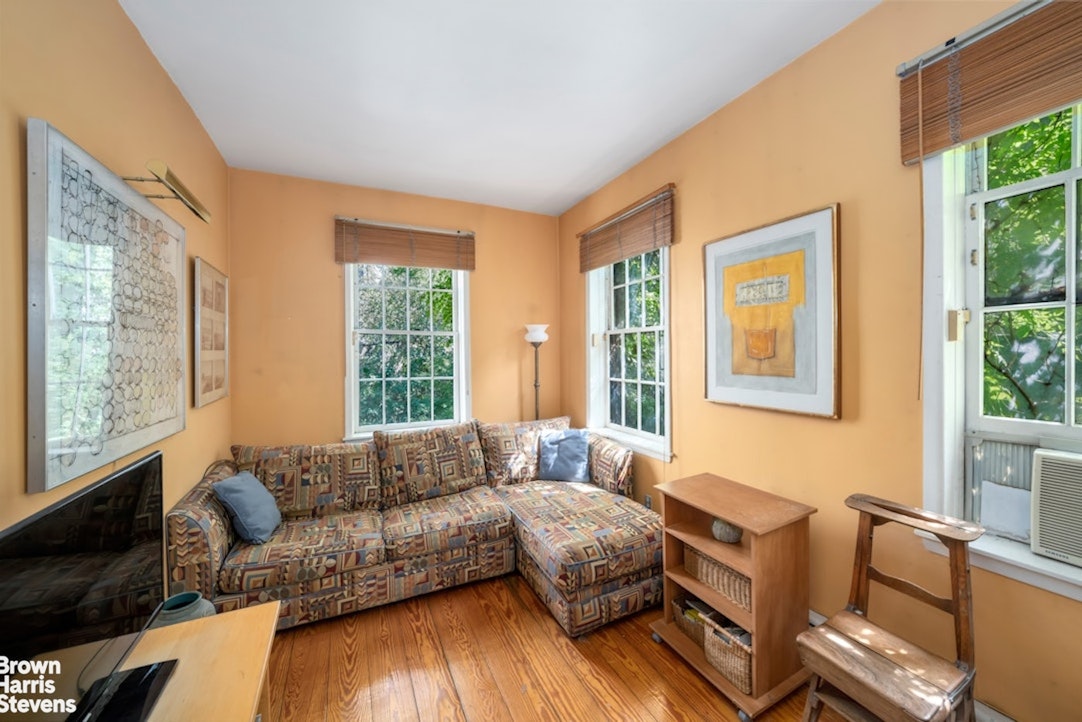 422 West 46th Street, Unit 2R Manhattan, NY 10036 - Photo 8 of 10 a living room with furniture and a window