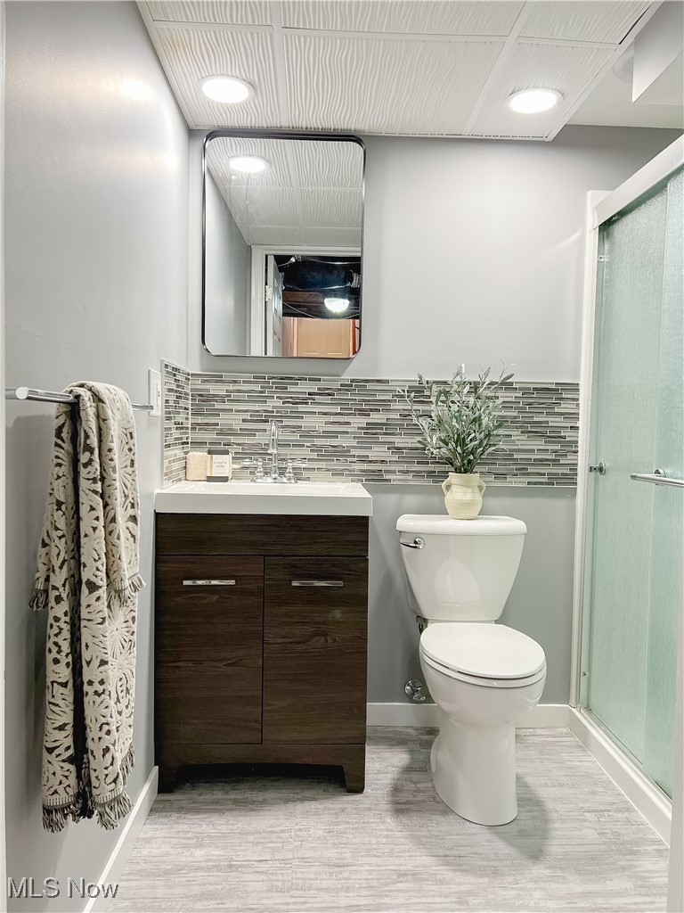 6403 Kenneth Avenue Parma, OH 44129 - Photo 19 of 20 Full bath with vanity, tasteful backsplash, a shower, and LVP flooring