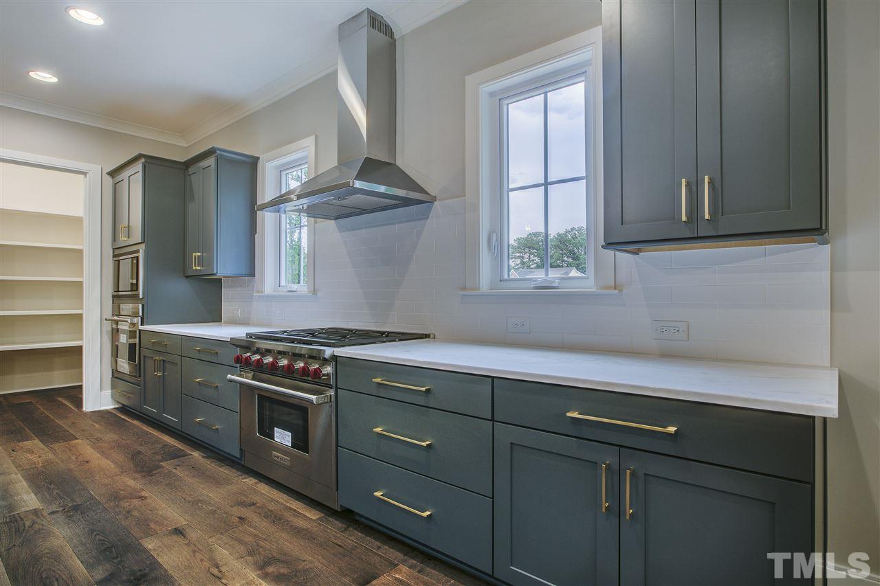 3061 Eden Harbor Court Raleigh, NC 27613 - Photo 14 of 30 a kitchen with a stove and a sink