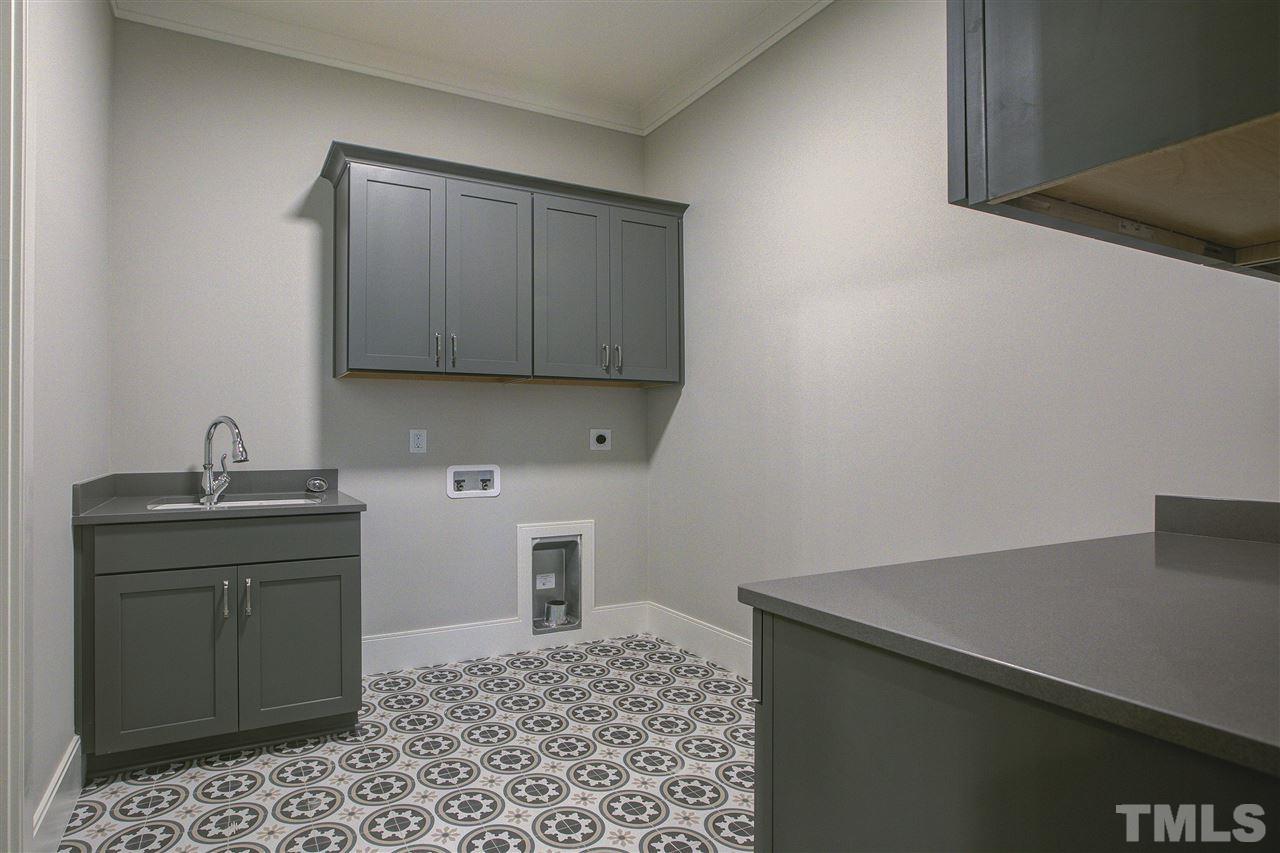3061 Eden Harbor Court Raleigh, NC 27613 - Photo 7 of 30 a kitchen with a sink cabinets and wooden floor