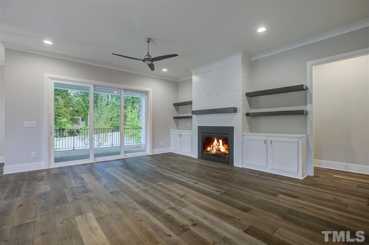 3061 Eden Harbor Court Raleigh, NC 27613 - Photo 8 of 30 a view of empty room with wooden floor and fireplace