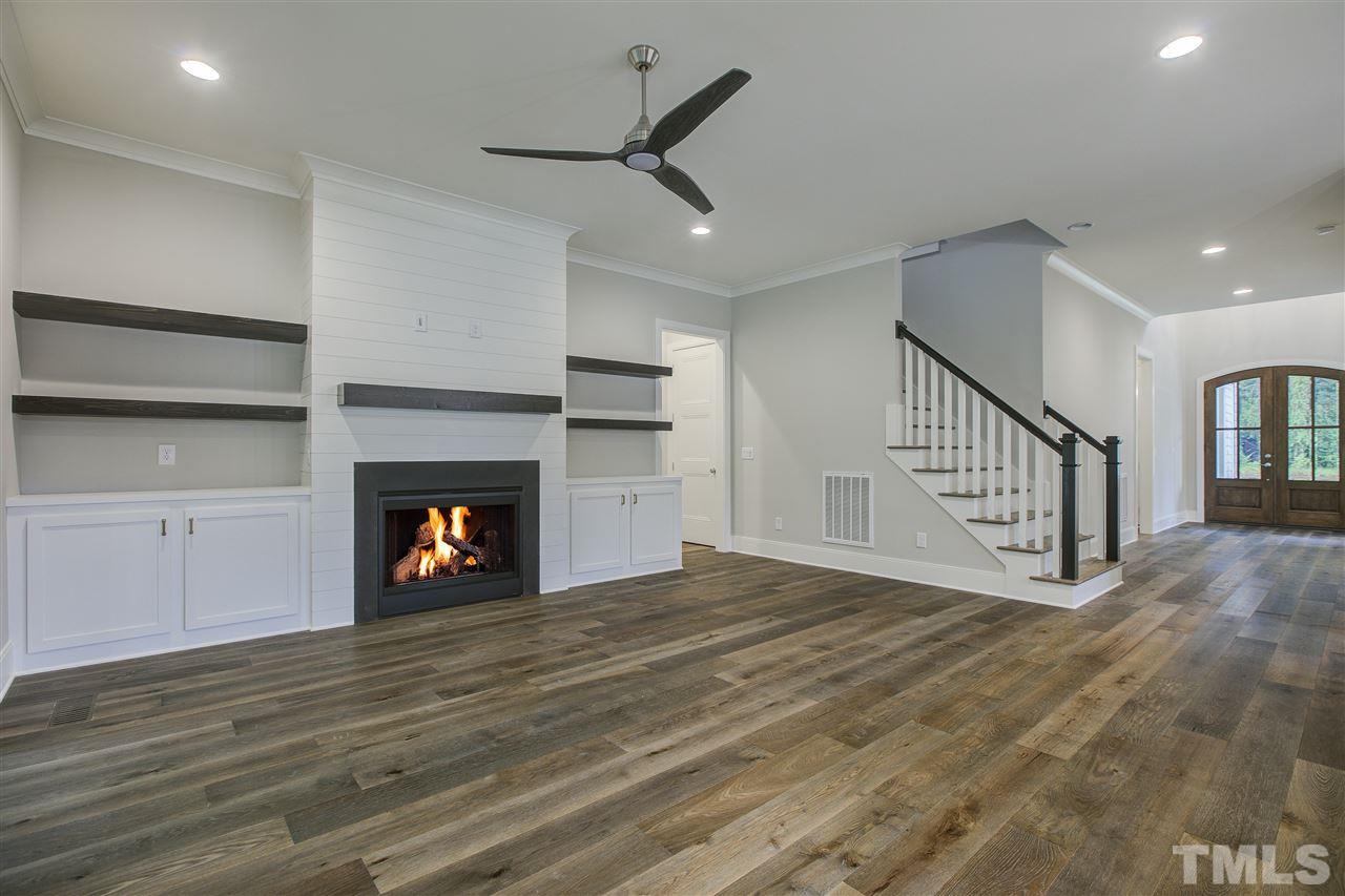 3061 Eden Harbor Court Raleigh, NC 27613 - Photo 9 of 30 a view of an empty room with wooden floor fireplace and a window
