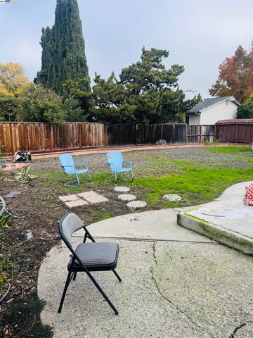 a backyard of a house with table and chairs