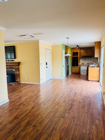 a view of a living room a kitchen and a wooden floor