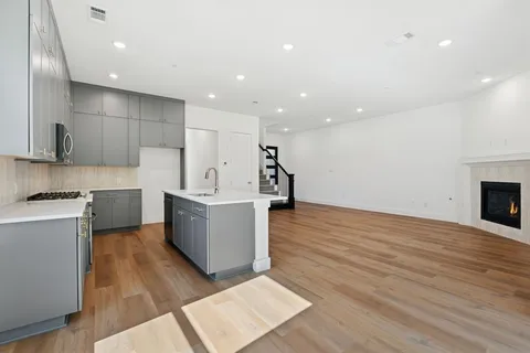 a kitchen with granite countertop a stove and a sink