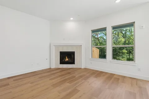 a open kitchen with kitchen island a sink wooden floor and a large window