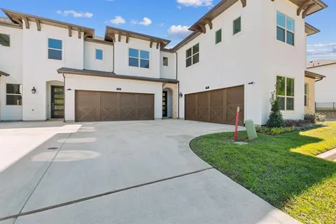 a front view of a house with a garden and yard