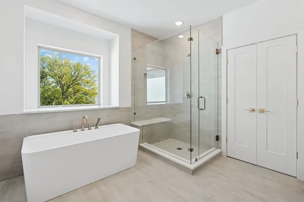 a spacious bathroom with a sink a toilet and a mirror