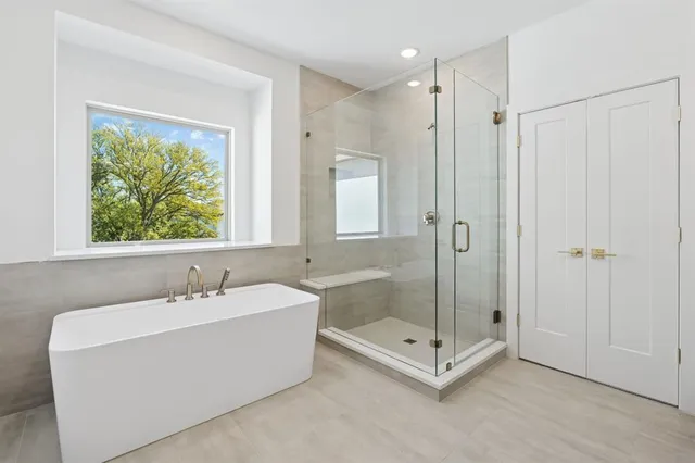 a spacious bathroom with a sink a toilet and a mirror