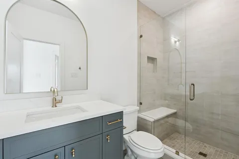 a bathroom with a sink a toilet and shower