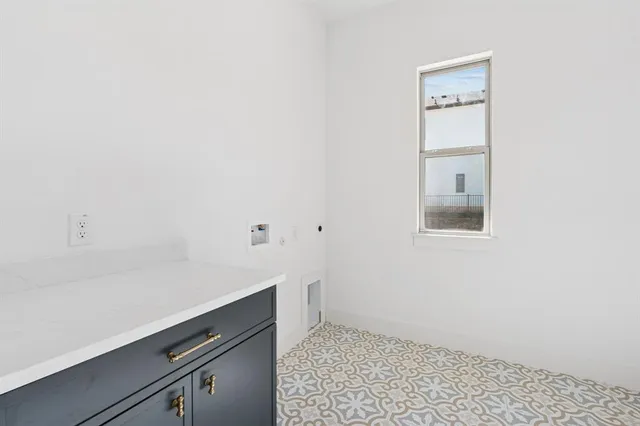 a room with a white wall and a stove