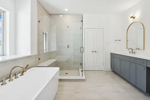 a large kitchen with stainless steel appliances a large counter top a stove and a refrigerator