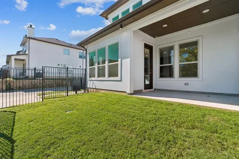 a bathroom with a tub sink double vanity and a mirror