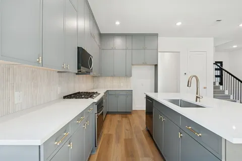 a view of kitchen with cabinets and wooden floor