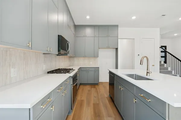 a view of kitchen with cabinets and wooden floor