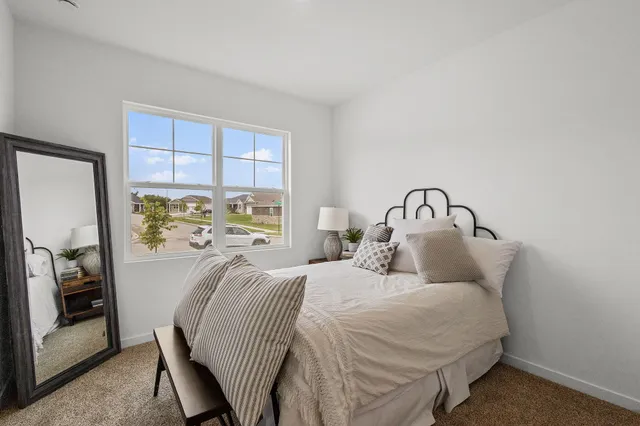 a bedroom with a bed next to a window with outer view