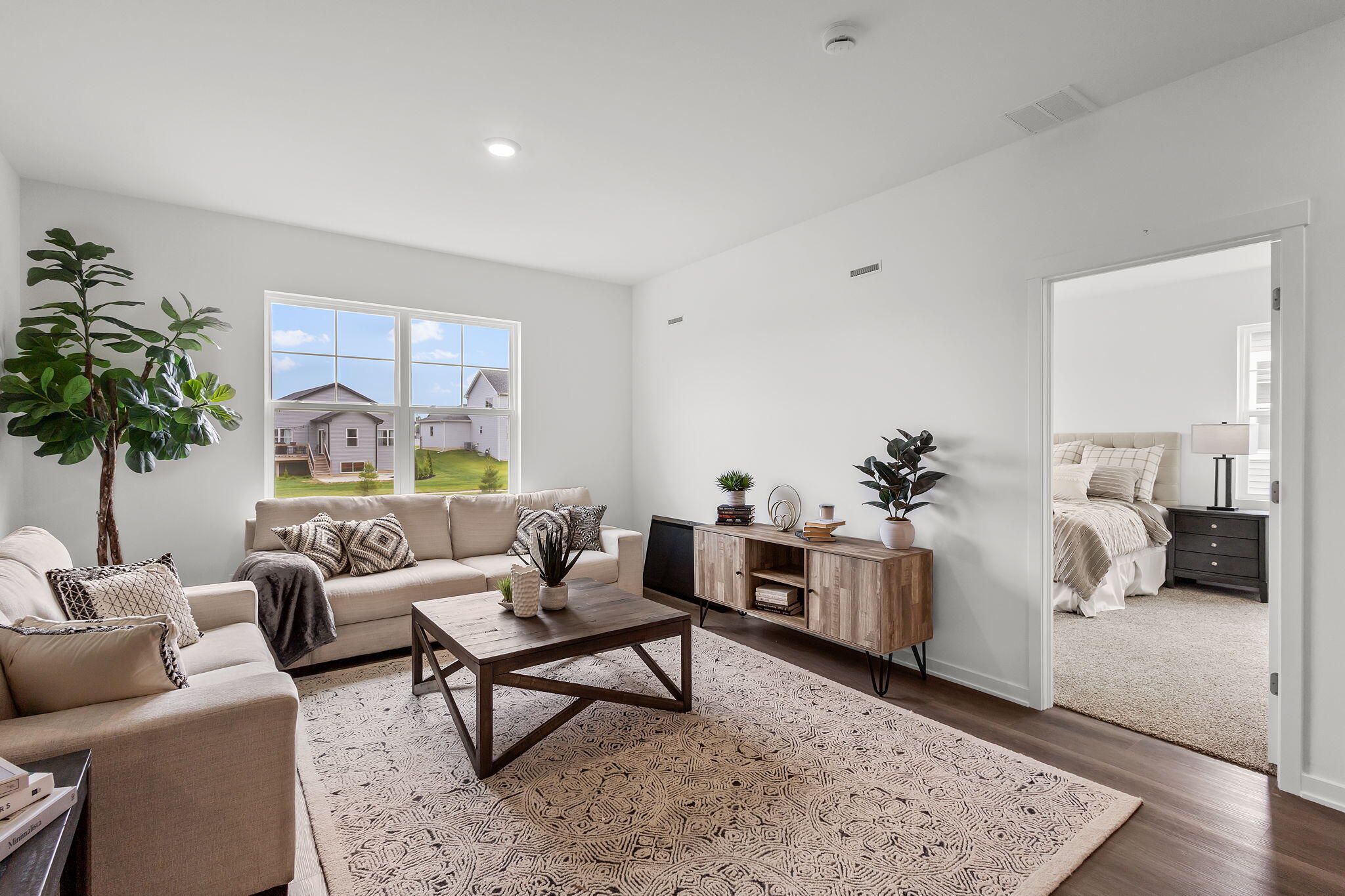 7486 East 116th Place Crown Point, IN 46307 - Photo 7 of 25 a living room with furniture and a potted plant