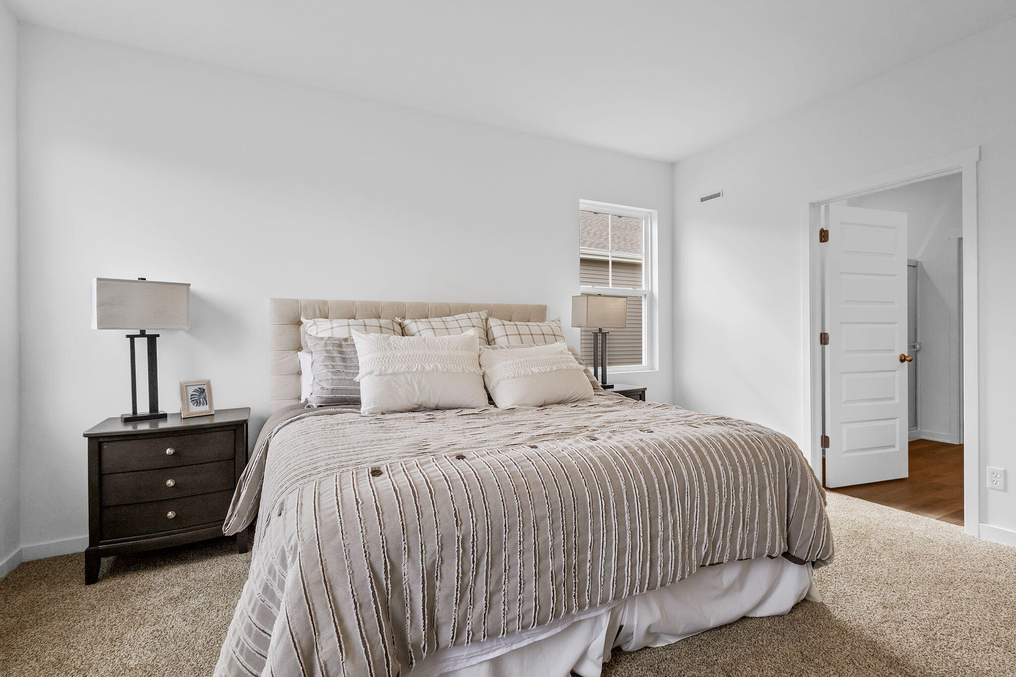 7486 East 116th Place Crown Point, IN 46307 - Photo 10 of 25 a bedroom with a bed and a night stand