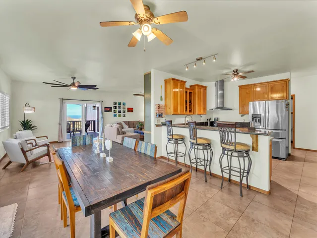 a view of a dining room with furniture and a kitchen