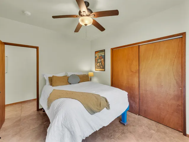 a bedroom with a bed and a large window