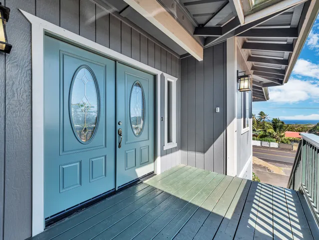 a view of a hallway with entryway wooden floor and front door