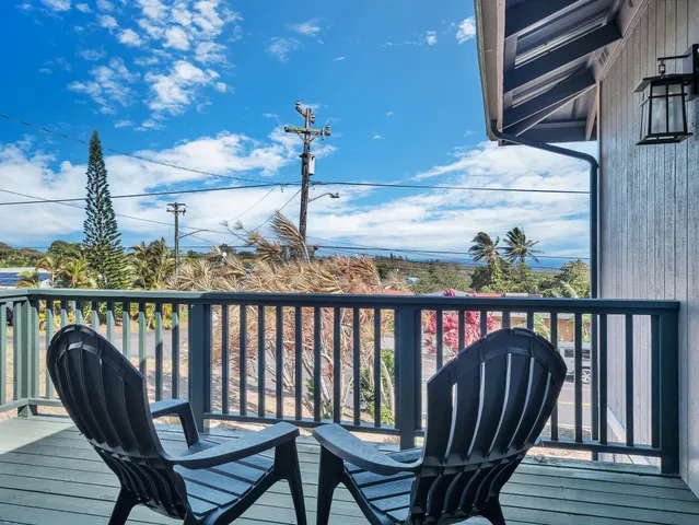 a view of a balcony with chairs