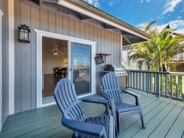 a view of a porch with furniture and wooden floor