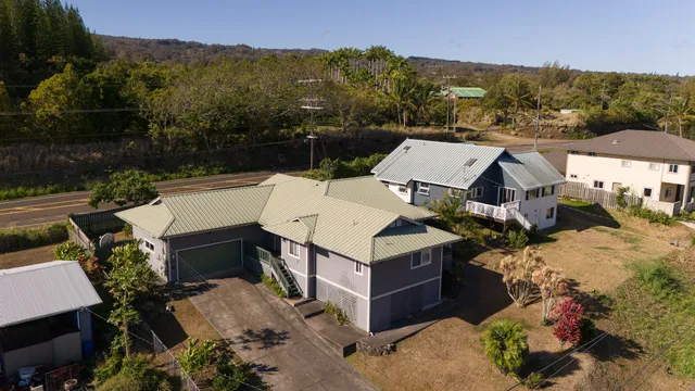 an aerial view of a house with a mountain