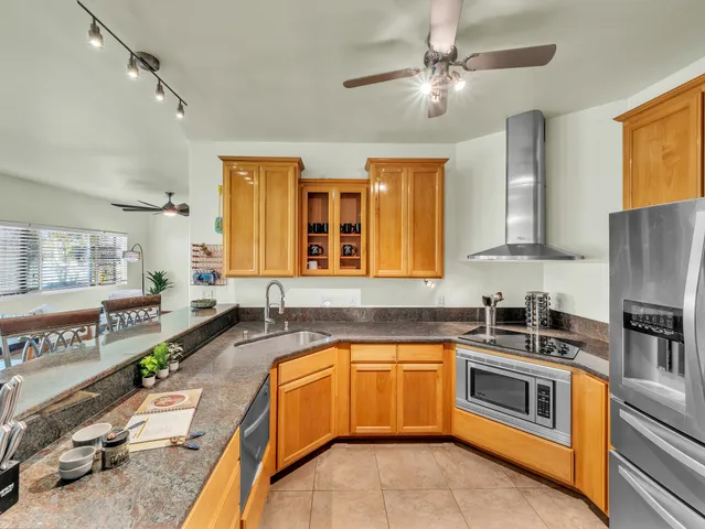 a kitchen with a stove a sink and a refrigerator