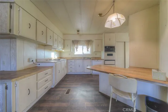 a kitchen with cabinets a sink and appliances