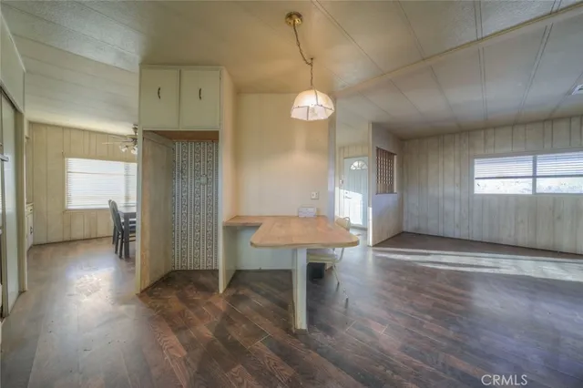 a view of a room with wooden floor and a window