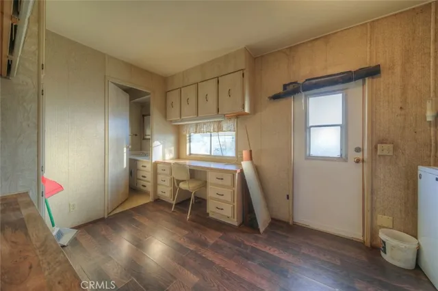 a view of empty room with wooden floor and fireplace
