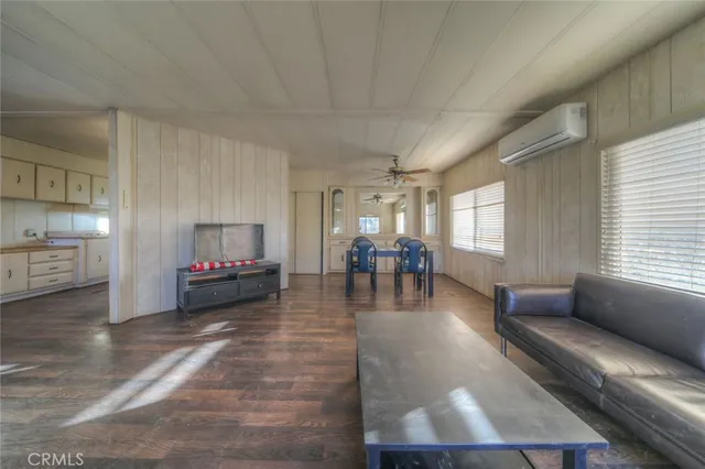 a living room with fireplace furniture and a wooden floor