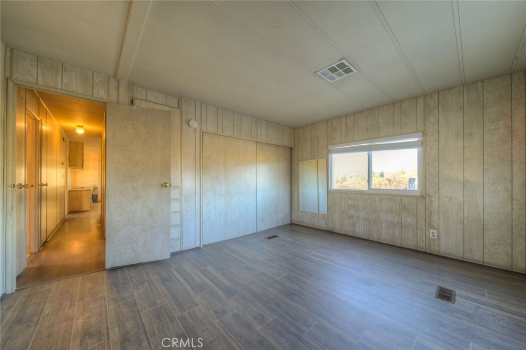 52565 Wheeler Road Anza, CA 92539 - Photo 35 of 54 a view of an empty room with wooden floor and a window
