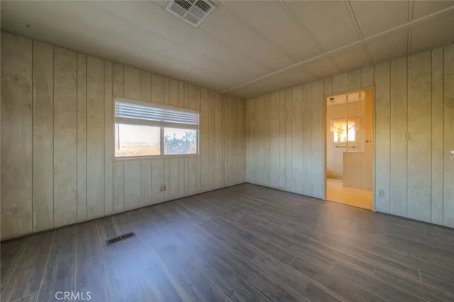 a view of a a dining room with furniture window and wooden floor