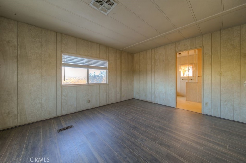 52565 Wheeler Road Anza, CA 92539 - Photo 38 of 54 an empty room with wooden floor and windows