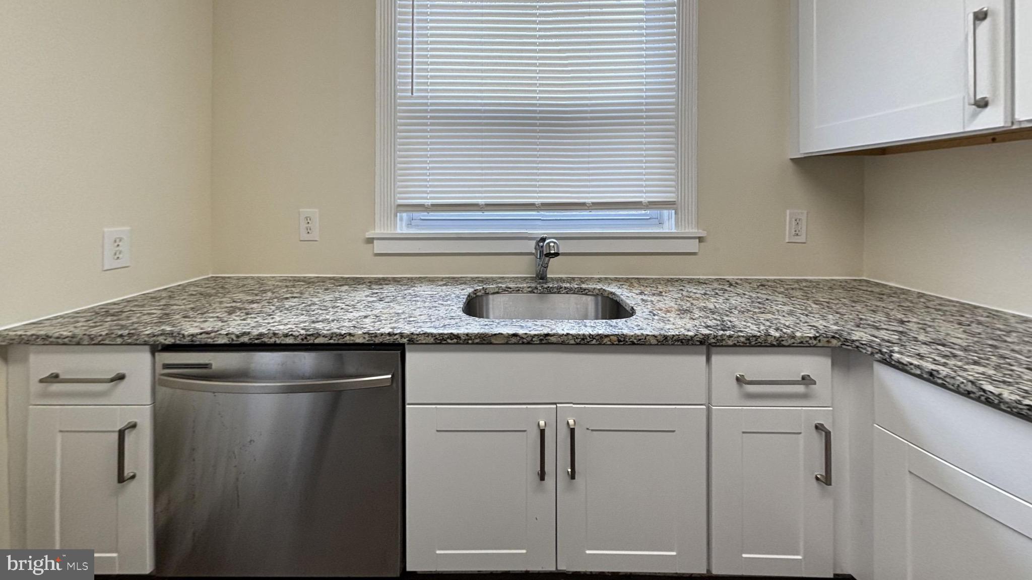 7246 Lamport Road Upper Darby, PA 19082 - Photo 2 of 10 a kitchen with granite countertop cabinets sink and window