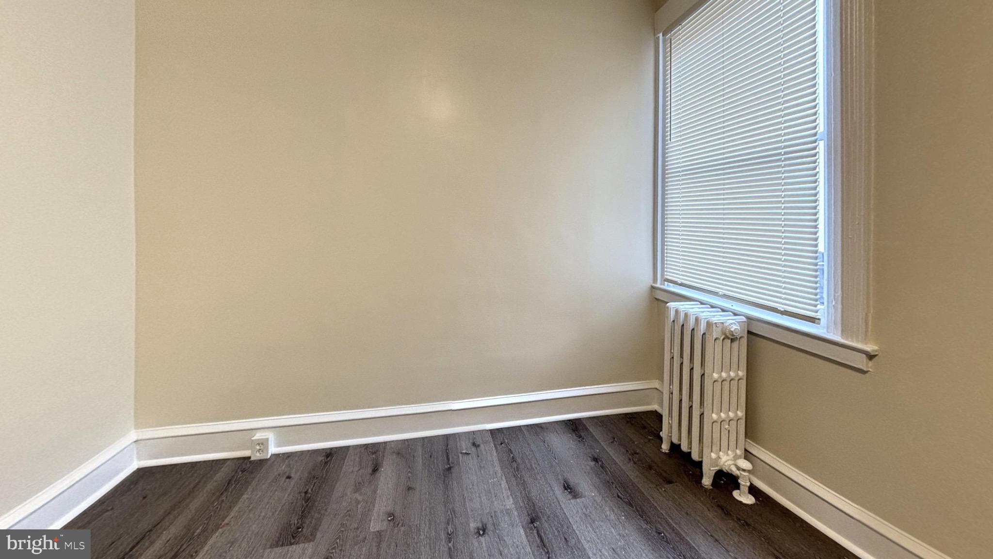 7246 Lamport Road Upper Darby, PA 19082 - Photo 5 of 10 an empty room with wooden floor and windows