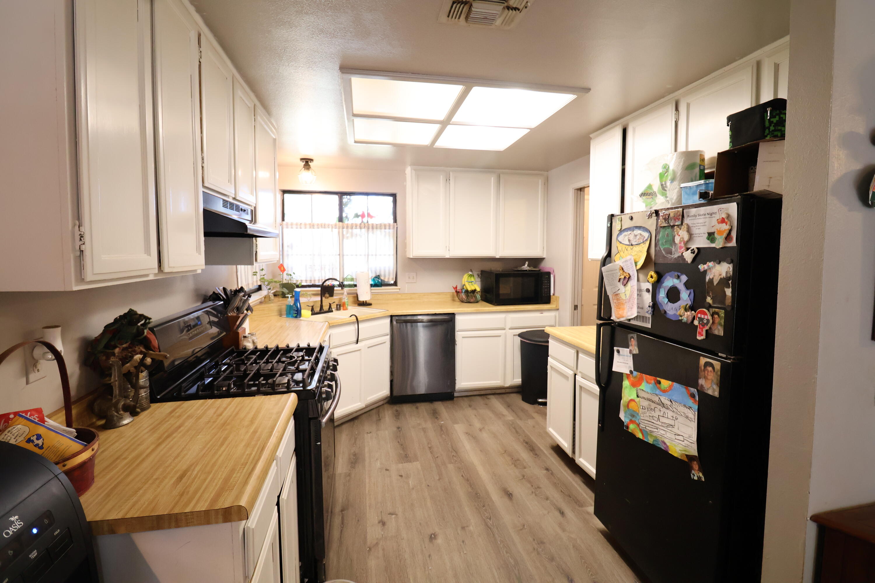 3528 Silverwood Street Redding, CA 96002 - Photo 3 of 13 a kitchen with stainless steel appliances a refrigerator sink and cabinets