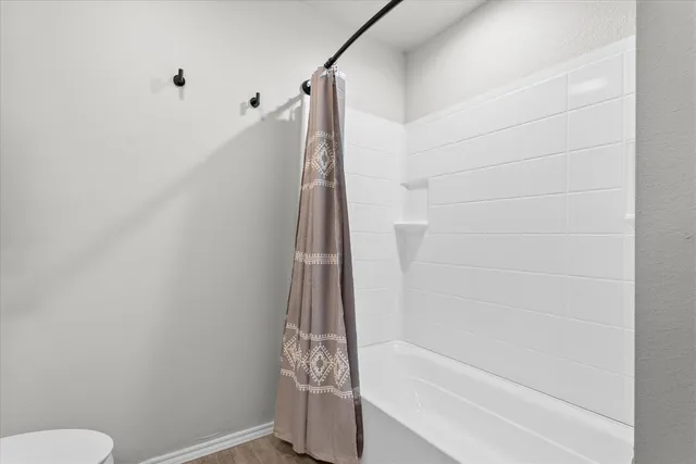 a bathroom with a shower and a toilet