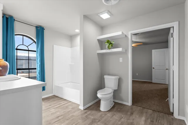wooden floor with closet and mirror