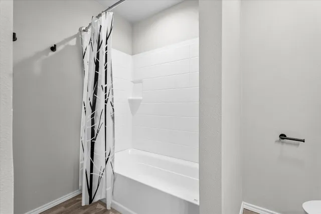 a view of a room with wooden floor