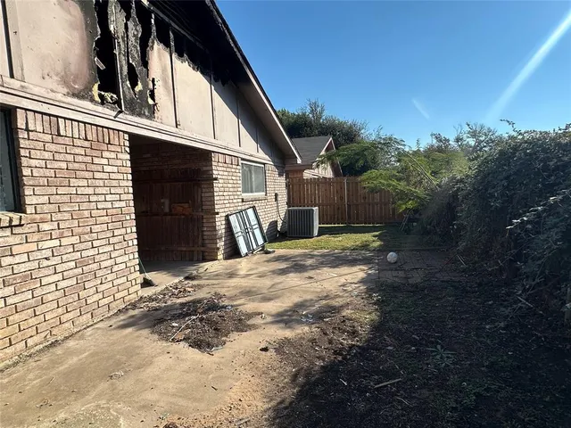 a backyard of a house with barbeque oven and seating space