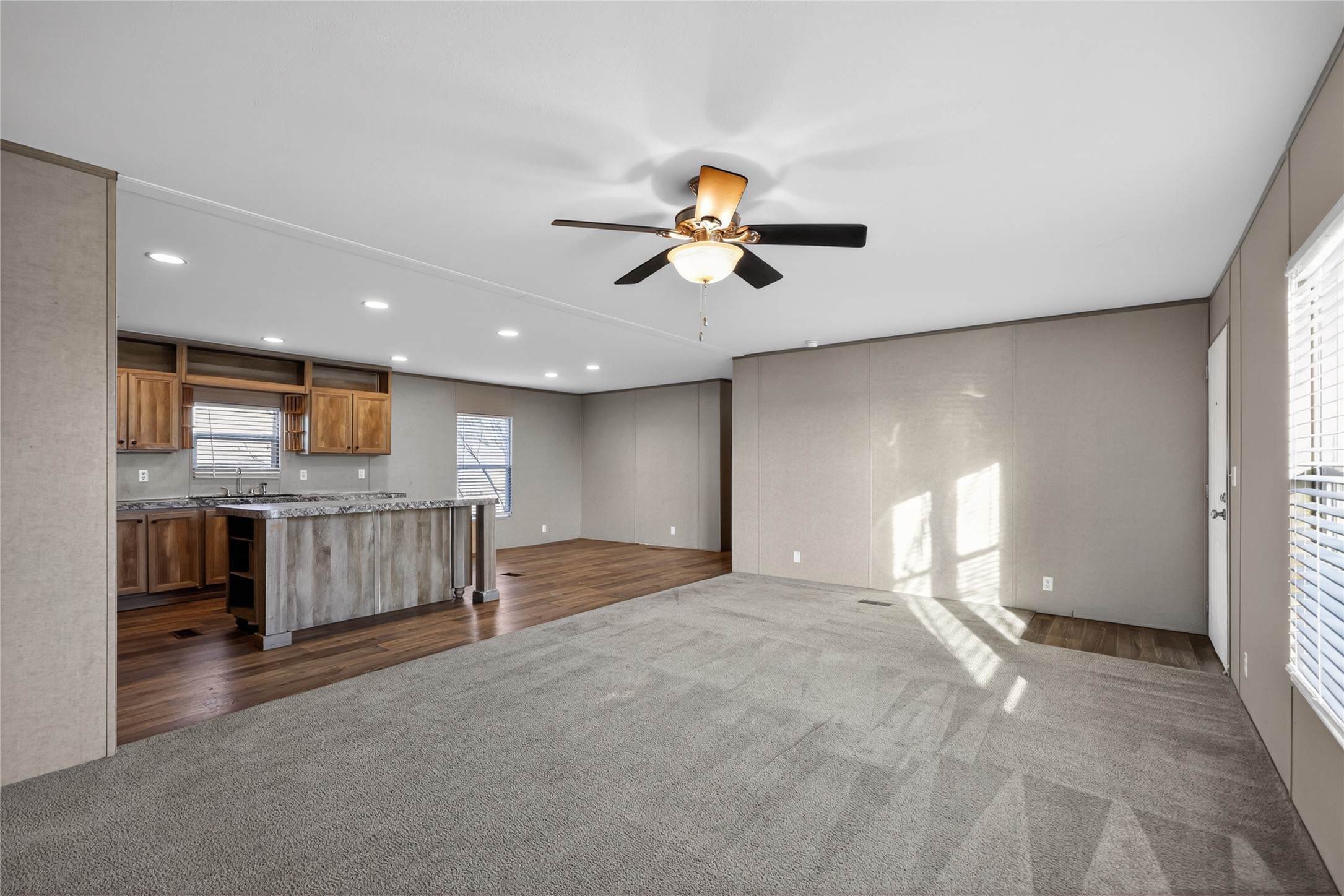 2674 Cotton Gin Road Kyle, TX 78640 - Photo 13 of 30 Unfurnished living room featuring recessed lighting, dark colored carpet, a ceiling fan, and dark wood-style flooring