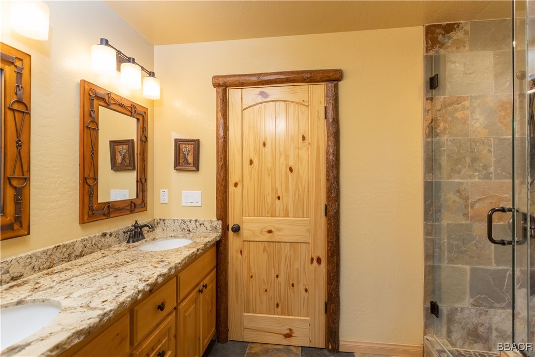 1389 Flintridge Avenue Big Bear City, CA 92314 - Photo 13 of 21 a bathroom with a granite countertop sink and a mirror