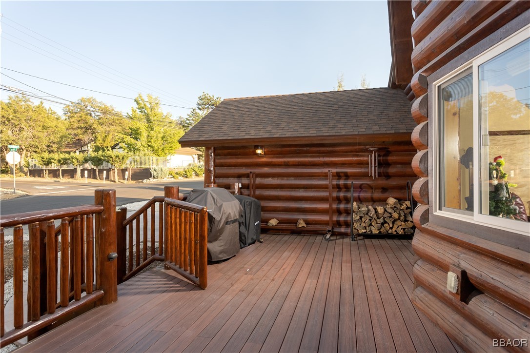 1389 Flintridge Avenue Big Bear City, CA 92314 - Photo 19 of 21 a view of a balcony with wooden floor and outdoor seating
